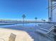 Resort-style pool deck with lounge chairs, palm trees, and a stunning waterfront view at 231 Riverside Dr # 1509-1, Holly Hill, FL 32117