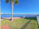 Scenic waterfront view with palm trees, a serene walking path, and clear blue skies at 231 Riverside Dr # 1509-1, Holly Hill, FL 32117