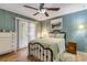 Charming bedroom with wood-look floors, ceiling fan, and access to the backyard at 2323 Queen Palm Dr, Edgewater, FL 32141