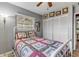 Cozy bedroom featuring neutral walls, closet, ceiling fan, and natural light from window at 2323 Queen Palm Dr, Edgewater, FL 32141