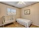 Bedroom with window and wood-look flooring, featuring a crib at 2323 Queen Palm Dr, Edgewater, FL 32141