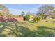 Well-kept front yard and partial view of house with chimney, offering privacy and curb appeal at 2323 Queen Palm Dr, Edgewater, FL 32141