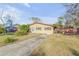 Inviting single-story home featuring a well-maintained lawn, driveway, and charming curb appeal at 2323 Queen Palm Dr, Edgewater, FL 32141