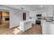 Bright white kitchen featuring quartz countertops, stainless steel appliances, and a center island at 2323 Queen Palm Dr, Edgewater, FL 32141