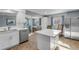 Bright kitchen with white cabinets, stainless steel appliances, and open view to the dining area at 2323 Queen Palm Dr, Edgewater, FL 32141