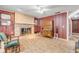 Inviting living room boasting a stone fireplace, wood-look floors, and classic decor at 2323 Queen Palm Dr, Edgewater, FL 32141