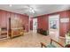 Open living room with wood-look floors, featuring a vintage cabinet and multiple entrances at 2323 Queen Palm Dr, Edgewater, FL 32141