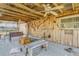 Spacious covered patio with seating, ceiling fans, and rustic wood accents at 2323 Queen Palm Dr, Edgewater, FL 32141