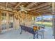 Covered patio space featuring rustic wood finishes, seating, and ceiling fans at 2323 Queen Palm Dr, Edgewater, FL 32141