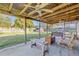 Large covered patio with bench seating, fans, and view to a spacious backyard at 2323 Queen Palm Dr, Edgewater, FL 32141