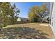 Spacious backyard with a grass lawn and a partial fence at 234 Meadow Lake Dr, Edgewater, FL 32141