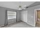 A gray carpeted bedroom includes a ceiling fan and a window with curtains at 234 Meadow Lake Dr, Edgewater, FL 32141