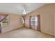 This spacious bedroom is bright with neutral paint, plush carpeting and lots of natural light at 234 Meadow Lake Dr, Edgewater, FL 32141