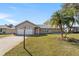 Charming brick home with palm trees and a two-car garage at 234 Meadow Lake Dr, Edgewater, FL 32141