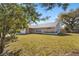 Well-maintained brick home with a green lawn and mature trees at 234 Meadow Lake Dr, Edgewater, FL 32141
