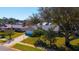 Beautiful single-story home with lush green lawn, mature trees, and a long driveway with parking at 234 Meadow Lake Dr, Edgewater, FL 32141