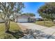 Charming brick home featuring a well-maintained lawn and a spacious two-car garage at 234 Meadow Lake Dr, Edgewater, FL 32141