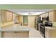 Open kitchen with stainless steel appliances, tile flooring and lots of counter space at 234 Meadow Lake Dr, Edgewater, FL 32141