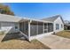 View of the screened porch of this home with access to the backyard and the house at 234 Meadow Lake Dr, Edgewater, FL 32141