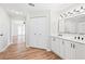 Bathroom vanity with double sinks, with closet and entryway to living area at 24 Coquina Point Dr, Ormond Beach, FL 32174