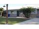 Single story home with brick and siding, metal roof, mature trees, and long driveway leading to a one car garage at 2404 Victory Palm Dr, Edgewater, FL 32141