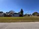 A home's exterior with a large lawn beneath a blue sky at 2404 Victory Palm Dr, Edgewater, FL 32141