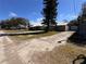 This exterior of home has a large driveway, trees, and a blue sky at 2404 Victory Palm Dr, Edgewater, FL 32141