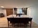 Kitchen area featuring a barn door, stainless steel appliances, large island with seating and stylish countertops at 2404 Victory Palm Dr, Edgewater, FL 32141