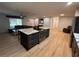 Modern kitchen island with stone countertops and stainless-steel appliances open to a cozy living area at 2404 Victory Palm Dr, Edgewater, FL 32141