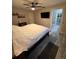 Main bedroom with view to bathroom and featuring a ceiling fan, hardwood floors, and neutral paint at 2404 Victory Palm Dr, Edgewater, FL 32141