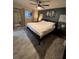 Inviting main bedroom with wood-look floors, a ceiling fan, and ample natural light at 2404 Victory Palm Dr, Edgewater, FL 32141