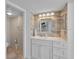 Bathroom with a modern vanity with marble countertops and a large mirror at 2625 S Atlantic Ave # 11Nw, Daytona Beach, FL 32118