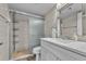Bathroom featuring a glass enclosed shower and a vanity with a framed mirror at 2625 S Atlantic Ave # 11Nw, Daytona Beach, FL 32118