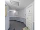 Hallway with gray walls, white trim, and a gray carpet in a condo building at 2625 S Atlantic Ave # 11Nw, Daytona Beach, FL 32118