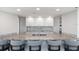 Kitchen bar featuring a granite countertop, sink and four gray bar stools at 2625 S Atlantic Ave # 11Nw, Daytona Beach, FL 32118