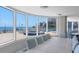 Bright living room with hardwood floors, views of the beach, and a long dining room table at 2625 S Atlantic Ave # 11Nw, Daytona Beach, FL 32118