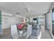 Condo living room with views, dining table, and access to a bedroom at 2625 S Atlantic Ave # 11Nw, Daytona Beach, FL 32118