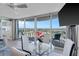 Condo living room with floor to ceiling windows, dining table, and access to an outdoor balcony at 2625 S Atlantic Ave # 11Nw, Daytona Beach, FL 32118