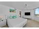 Bright main bedroom with a ceiling fan, large windows, and stylish white furniture at 2625 S Atlantic Ave # 11Nw, Daytona Beach, FL 32118