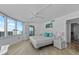 Comfortable main bedroom featuring large windows with a partial ocean view and ensuite bath at 2625 S Atlantic Ave # 11Nw, Daytona Beach, FL 32118