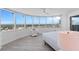 Bright main bedroom with floor-to-ceiling windows offering a panoramic city view at 2625 S Atlantic Ave # 11Nw, Daytona Beach, FL 32118