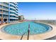 Outdoor pool with ocean views, chaise lounges, and a beach backdrop for relaxation at 2625 S Atlantic Ave # 11Nw, Daytona Beach, FL 32118