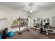 Carpeted exercise room featuring a weight machine, mirrors, and a bright interior at 2815 Bay Side Dr, New Smyrna Beach, FL 32168