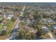 Expansive aerial view of a community with mature trees and well-maintained homes along a straight road at 3003 Tamarind Dr, Edgewater, FL 32141