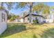 Backyard featuring mature landscaping, an outdoor shed and a well-manicured lawn at 3003 Tamarind Dr, Edgewater, FL 32141