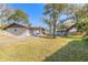 Large backyard featuring mature trees, a shed and a well-maintained lawn at 3003 Tamarind Dr, Edgewater, FL 32141