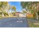 View of the backyard with wooden fence and access road at 3003 Tamarind Dr, Edgewater, FL 32141