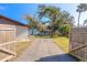 Backyard with a large tree, shed and fenced perimeter at 3003 Tamarind Dr, Edgewater, FL 32141
