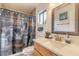 Bathroom with a modern sink, vanity, and shower featuring unique shower curtain and decorations at 3003 Tamarind Dr, Edgewater, FL 32141