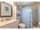 Bathroom featuring a blue themed shower curtain and decor, a white sink and tiled walls at 3003 Tamarind Dr, Edgewater, FL 32141